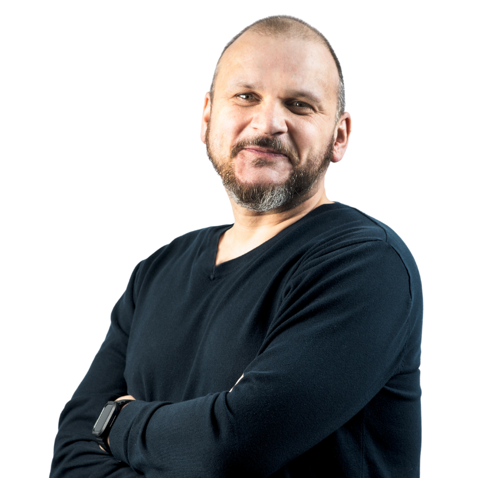 Smiling person in black shirt with folded arms.