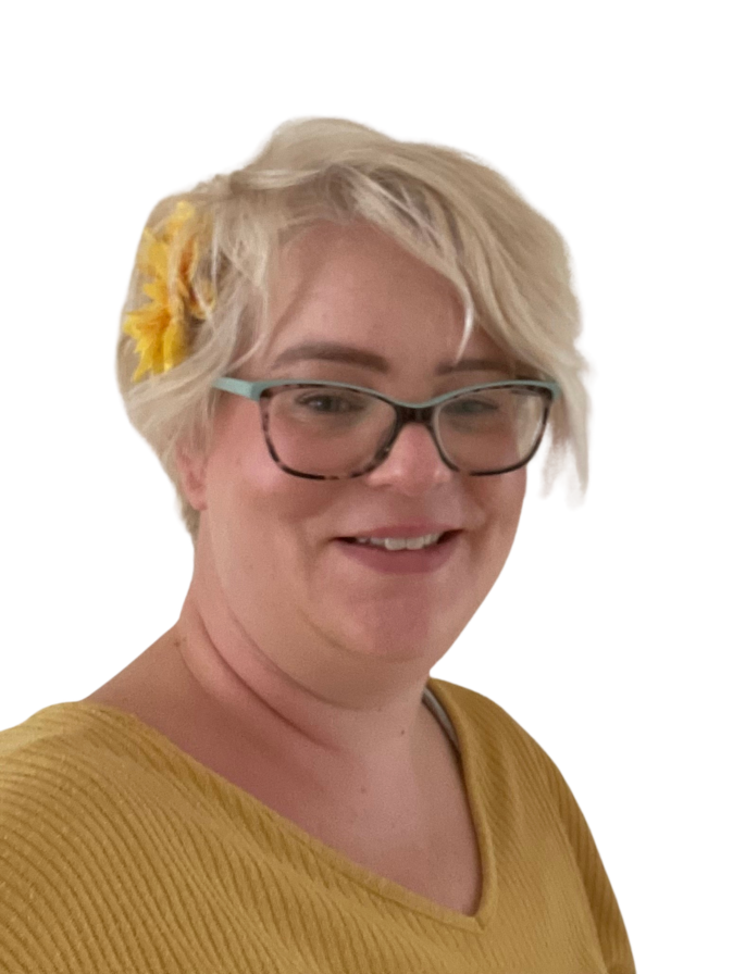 Smiling person with glasses and yellow top