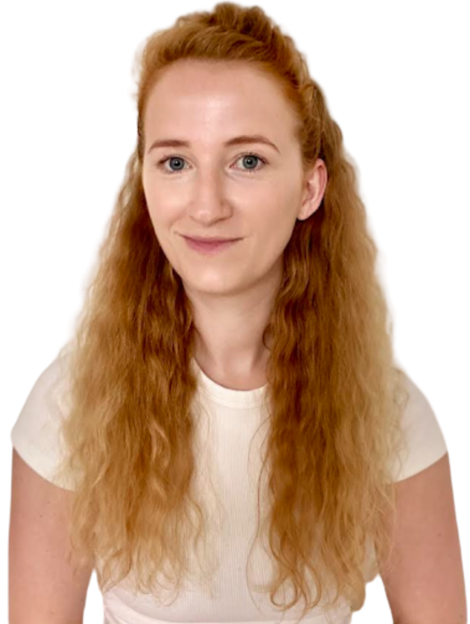 Person with long red hair smiling at camera.